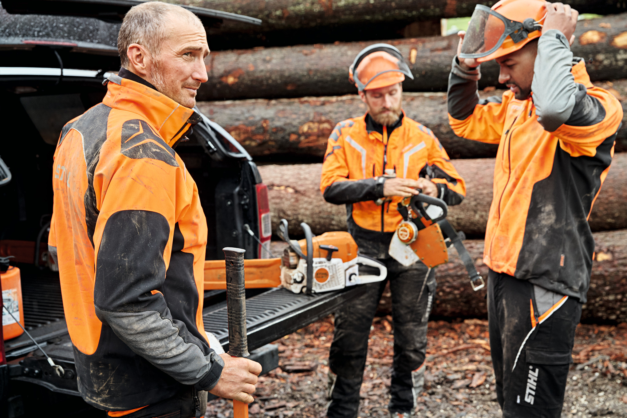 Group of forestry workers next to vehicle with protective equipment STIHL ADVANCE X-SHELL and STIHL ADVANCE X-VENT