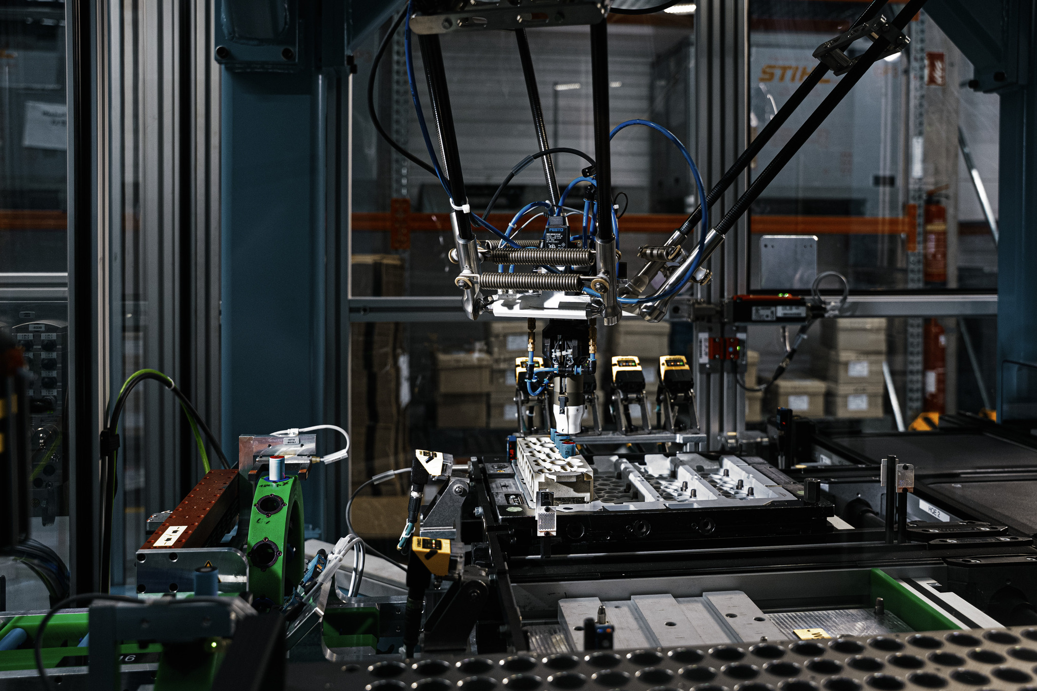 Robotic arms assemble battery cells in factory