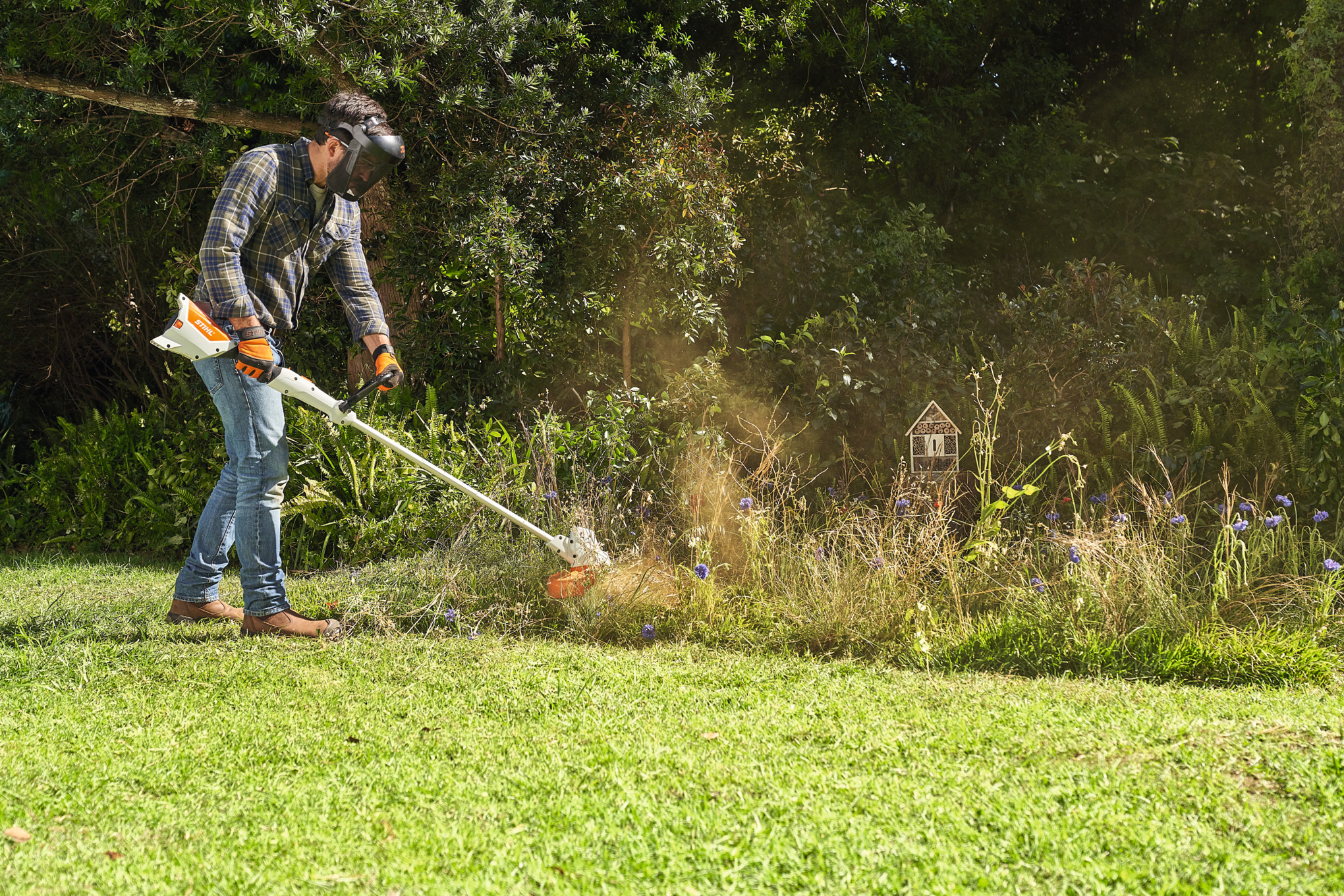 A man mowing flower meadow with FSA 57