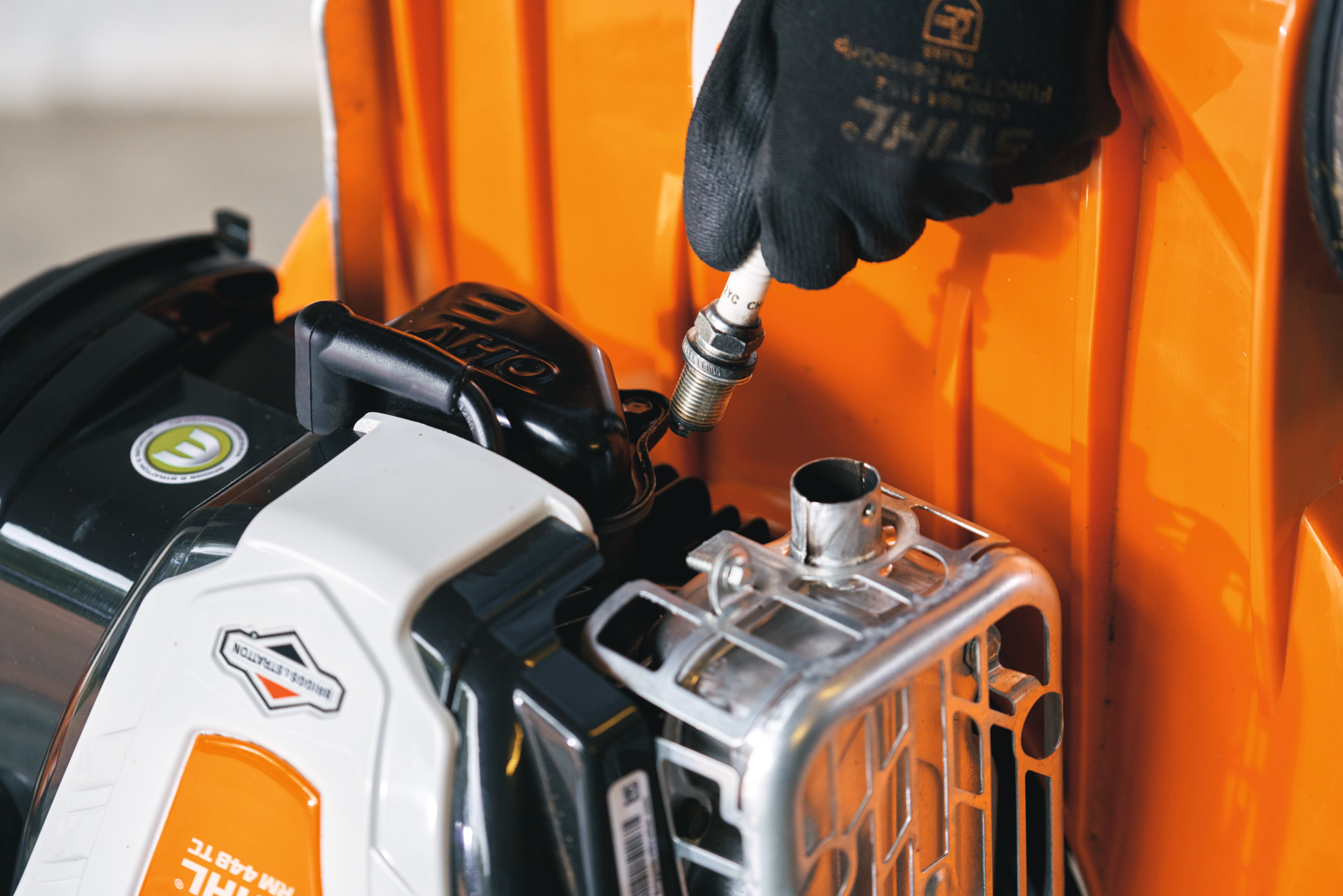 Removing a spark plug from a STIHL lawn mower