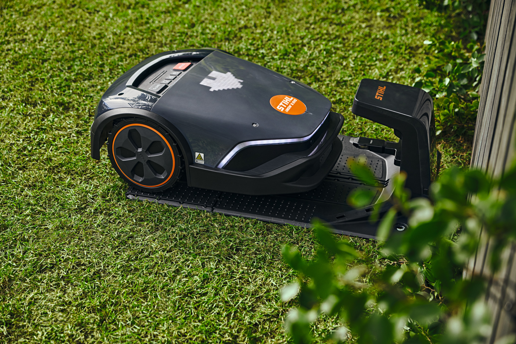 Close-up of a STIHL iMOW® 422 robot lawn mower being cleaned with a cloth
