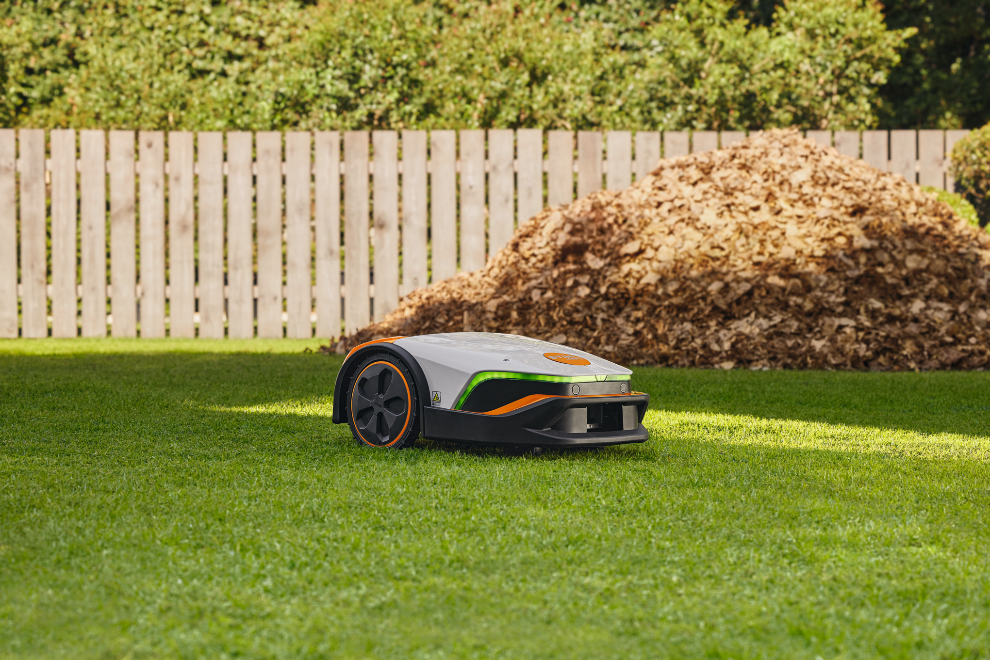 A STIHL iMOW® robot mower on a green lawn