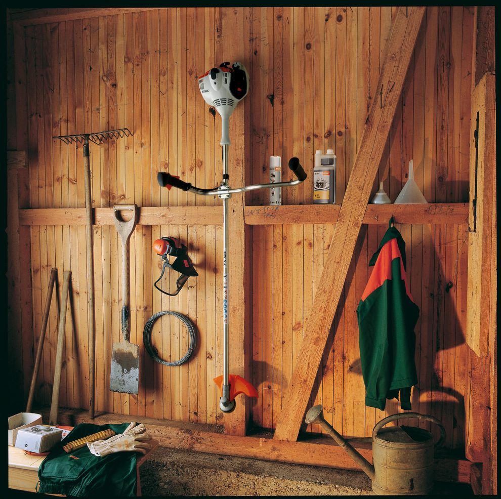 STIHL FS 56 brushcutter hanging in a tool shed for safe storage