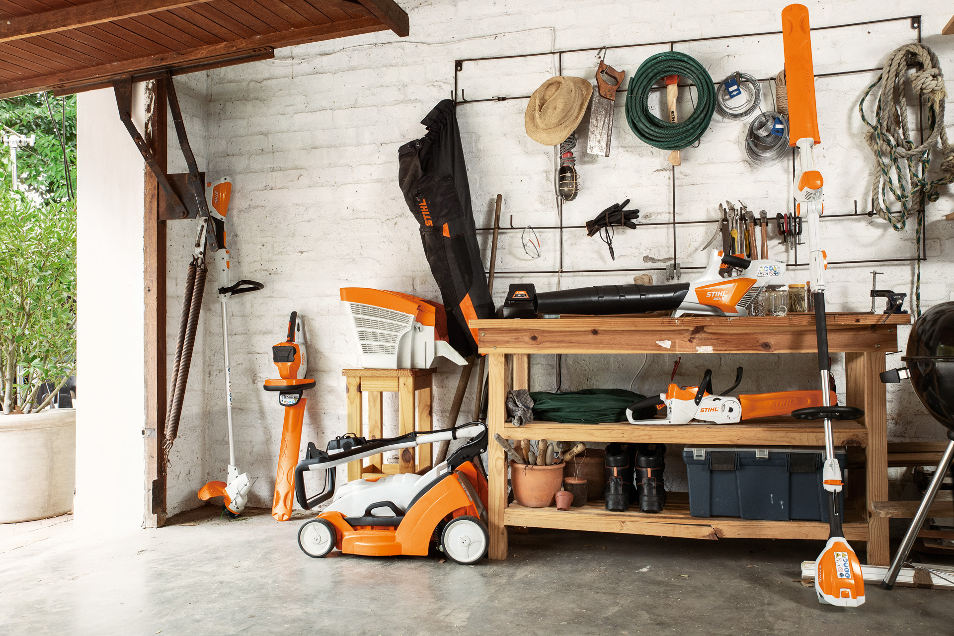 A garage interior with a wide range of STIHL products including an FSA 56 cordless grass trimmer.