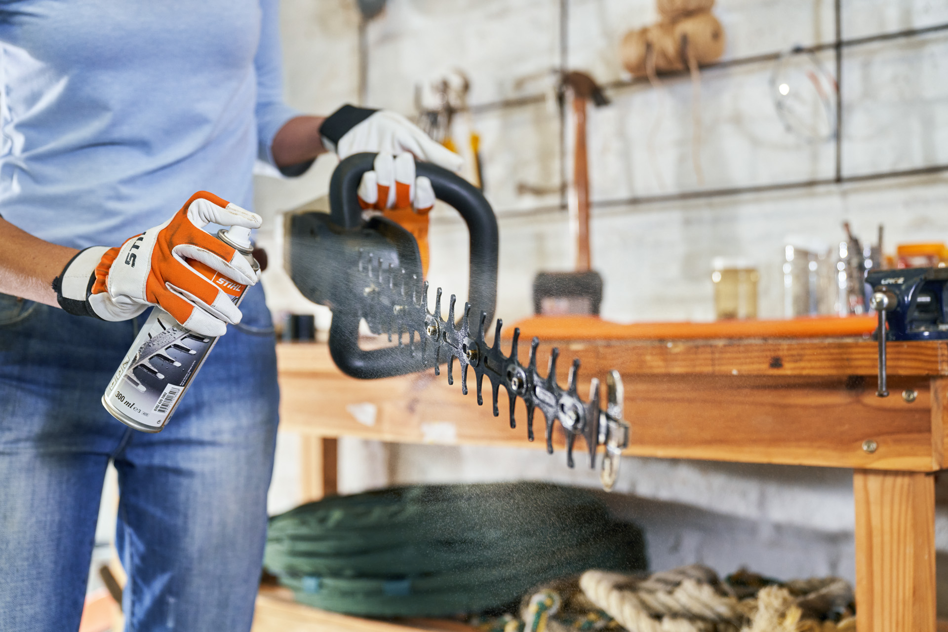 STIHL technician inspecting hedge trimmer blades at service counter