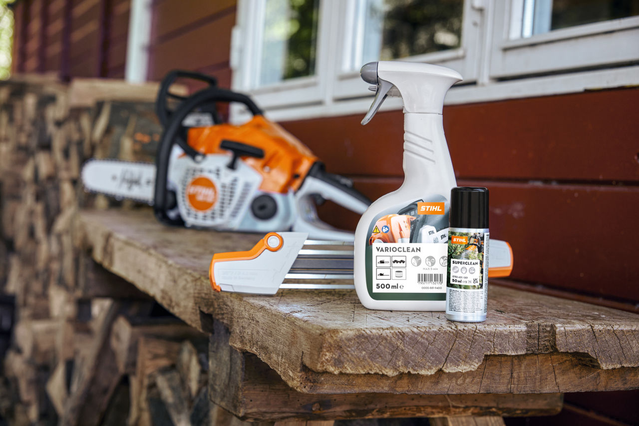 chainsaw on a bench with cleaning agent, file and lubricant