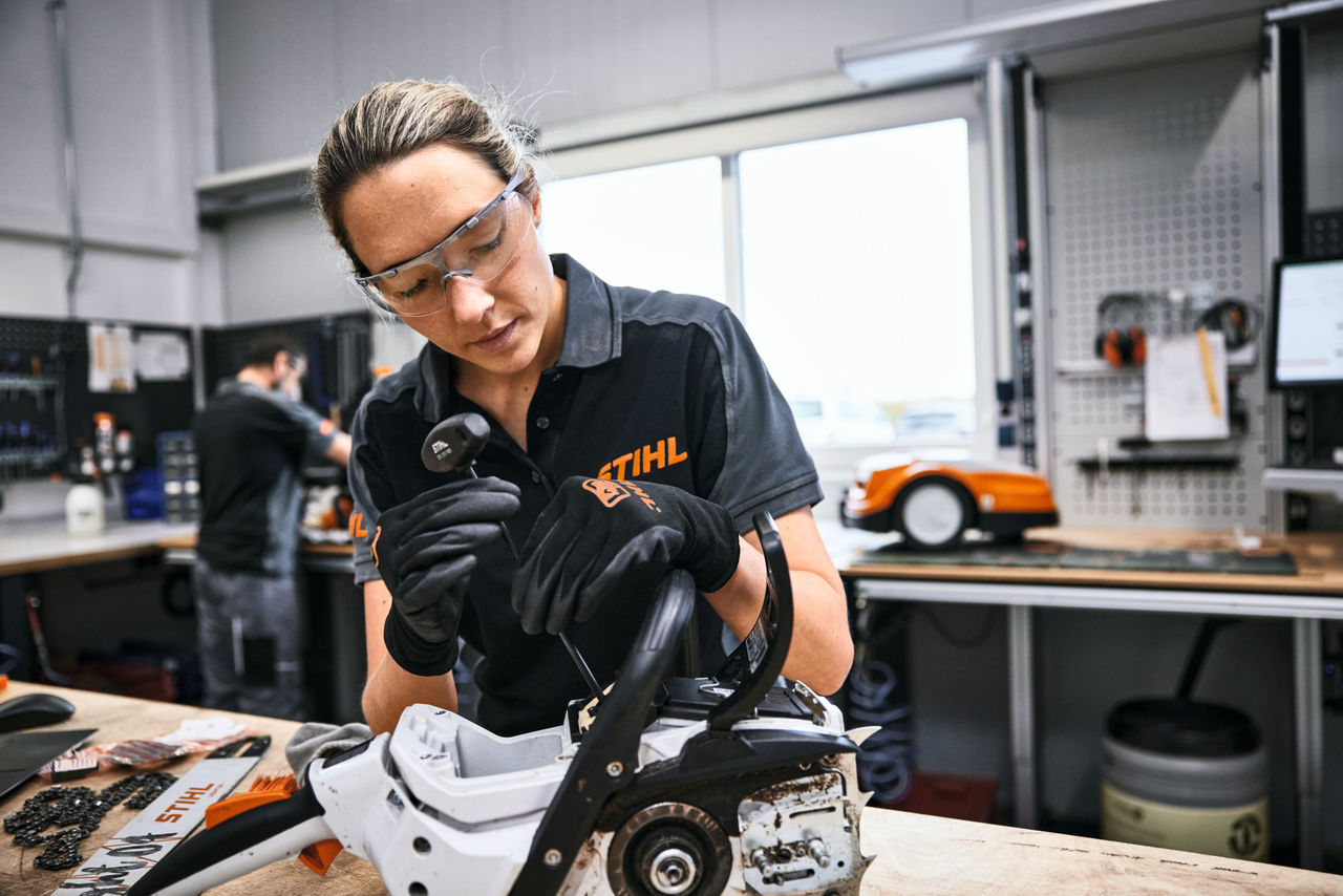 Service technician in product maintenance at a workbench